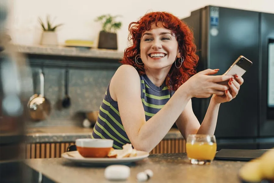 Woman smiling with a phone in her hand